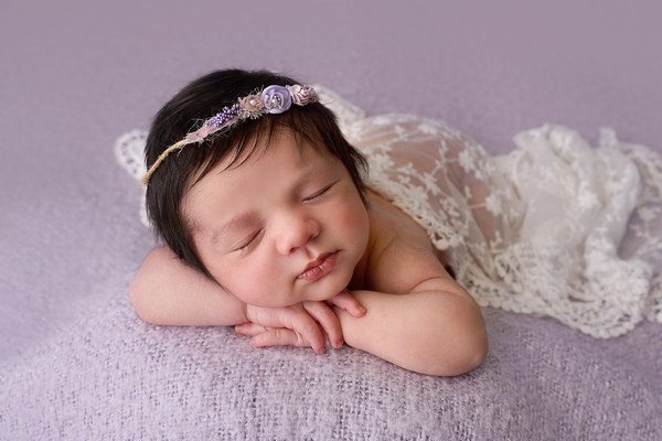 newborn baby on lilac blanket